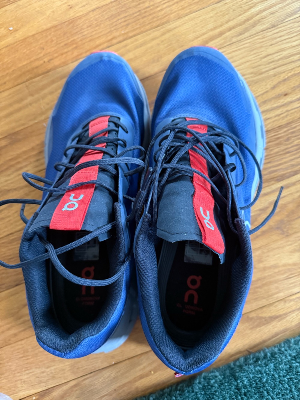 On Running Men’s Blue Athletic Shoes with Red Tongue Accents